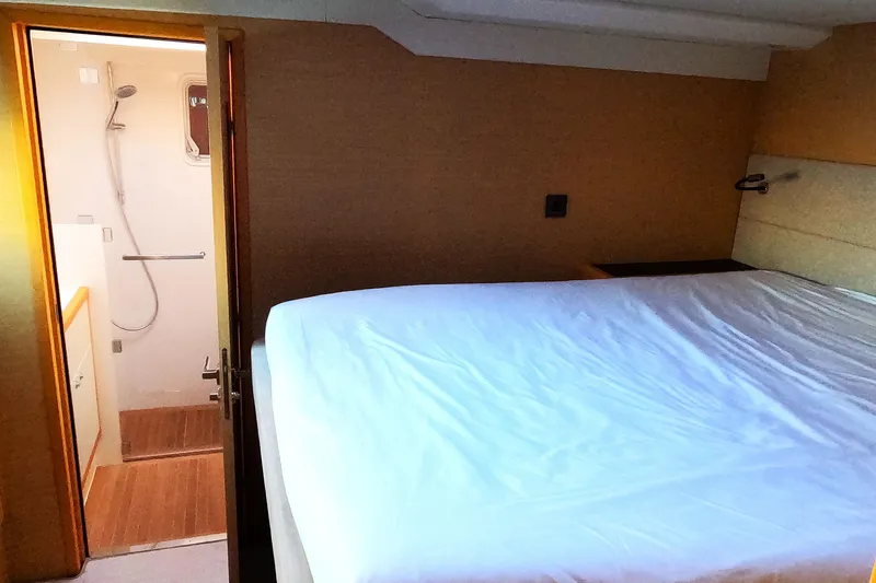  Yacht Photos Pics Luxurious bedroom and bathroom in 2024 Lagoon 620 NEO yacht.