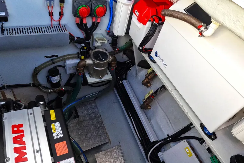  Yacht Photos Pics Engine room of 2024 Lagoon 620 NEO yacht with mechanical components and wiring.