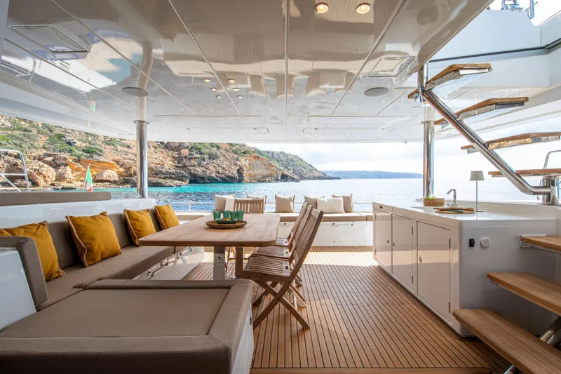  Yacht Photos Pics Luxurious 2024 Lagoon 620 NEO yacht interior with ocean view and elegant seating area.