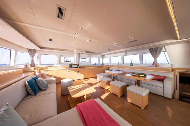  Yacht Photos Pics Luxurious interior of 2024 Lagoon 620 NEO yacht with modern furnishings and panoramic windows.
