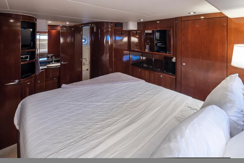 Persistence Yacht Photos Pics Luxurious interior of 2010 Meridian 580 Pilothouse yacht with wood paneling and cozy bedding.