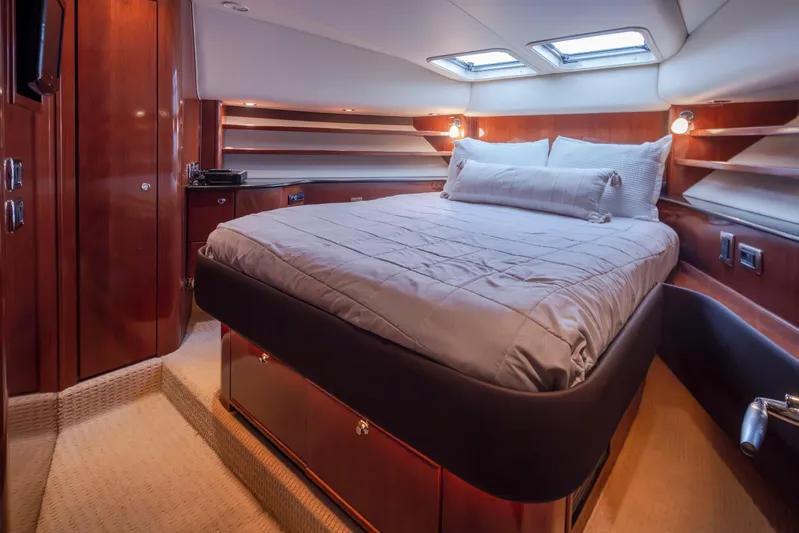 Persistence Yacht Photos Pics Luxurious bedroom interior of 2010 Meridian 580 Pilothouse yacht with elegant wood finishes.