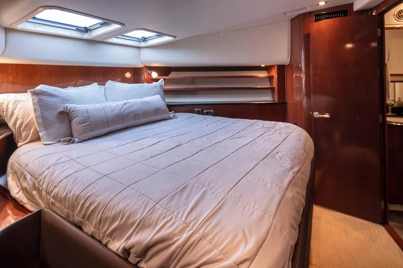 Persistence Yacht Photos Pics Luxurious bedroom interior of 2010 Meridian 580 Pilothouse yacht with plush bedding.