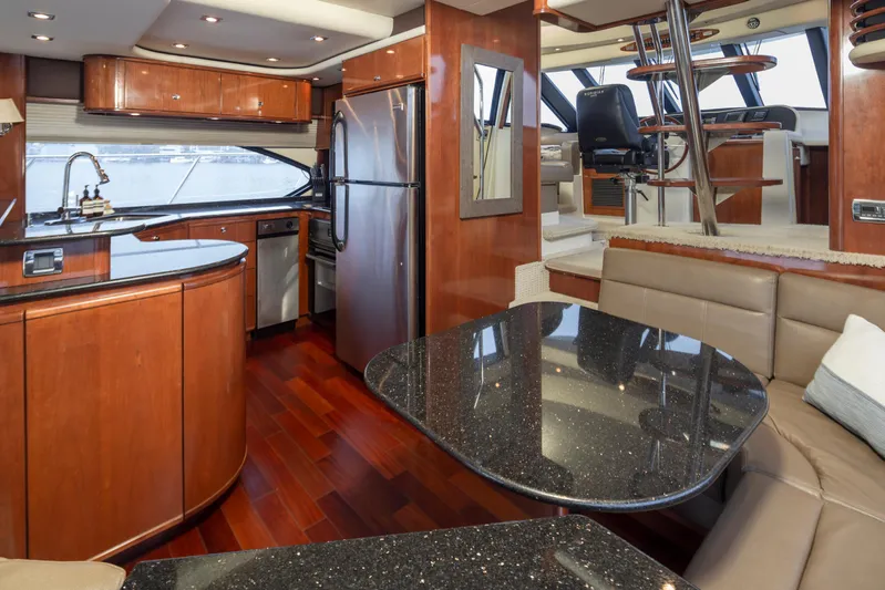 Persistence Yacht Photos Pics Luxurious interior of 2010 Meridian 580 Pilothouse yacht with modern kitchen and seating area.