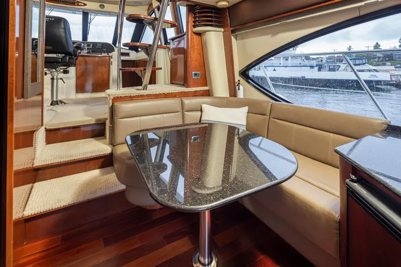 Persistence Yacht Photos Pics Luxurious interior of 2010 Meridian 580 Pilothouse yacht with elegant seating and table.