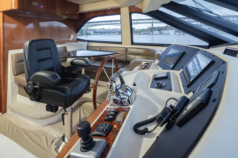 Persistence Yacht Photos Pics Interior of 2010 Meridian 580 Pilothouse with helm, controls, and seating area.