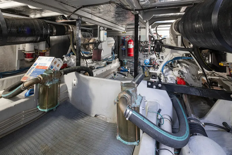 Persistence Yacht Photos Pics Engine room of 2010 Meridian 580 Pilothouse yacht, showcasing mechanical components and fire extinguisher.