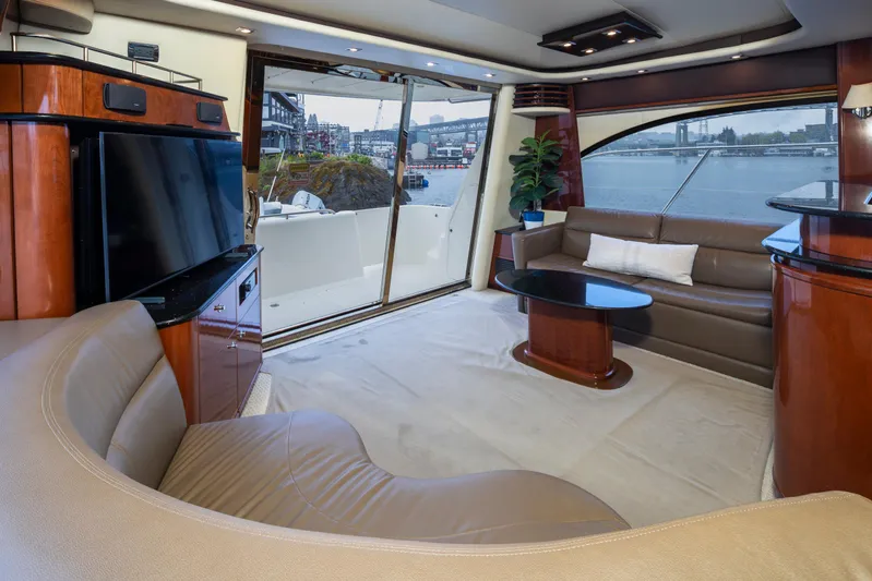 Persistence Yacht Photos Pics Luxurious interior of 2010 Meridian 580 Pilothouse yacht with elegant seating and waterfront view.