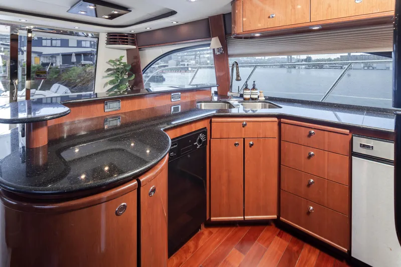 Persistence Yacht Photos Pics Luxurious kitchen interior of 2010 Meridian 580 Pilothouse yacht with sleek wood cabinetry.