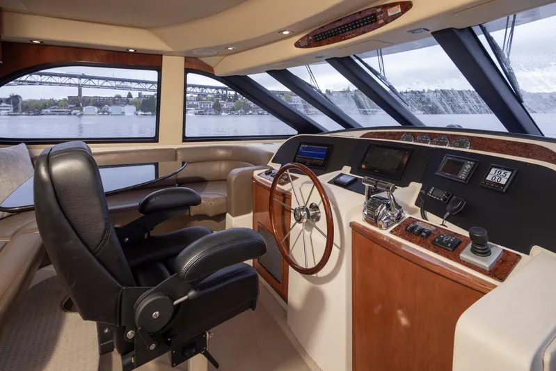 Persistence Yacht Photos Pics Pilothouse interior of 2010 Meridian 580, featuring helm controls and panoramic windows.