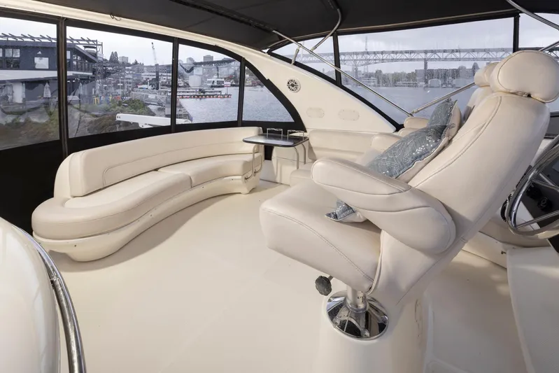 Persistence Yacht Photos Pics Luxurious interior of 2010 Meridian 580 Pilothouse yacht with plush seating and panoramic windows.