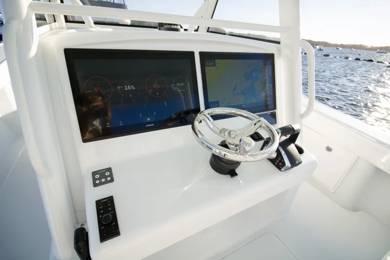  Yacht Photos Pics 2024 Yellowfin 39 boat dashboard with dual screens and steering wheel.