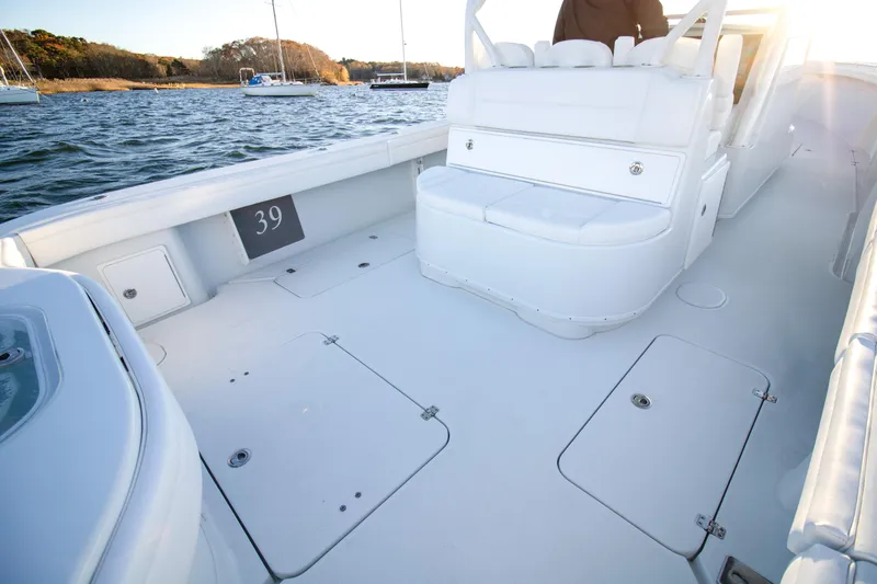  Yacht Photos Pics 2024 Yellowfin 39 boat deck with white seating and storage compartments.