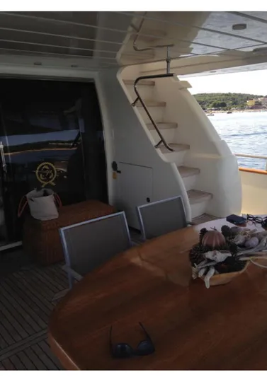  Yacht Photos Pics 2005 Canados 86 Fly yacht interior with dining area and staircase.