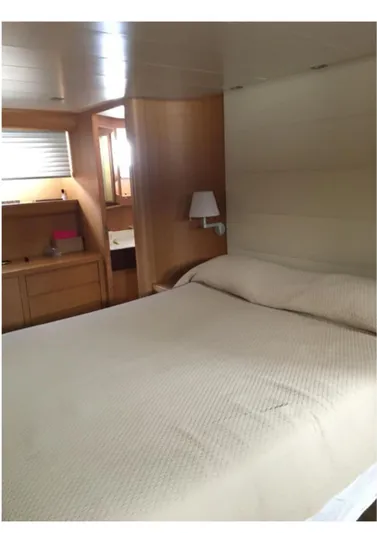  Yacht Photos Pics Luxurious bedroom interior of 2005 Canados 86 Fly yacht with modern wooden furnishings.