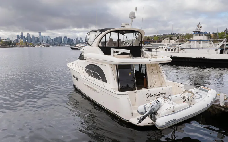 Persistence Yacht Photos Pics 2010 Meridian 580 Pilothouse yacht docked in a marina with city skyline backdrop.