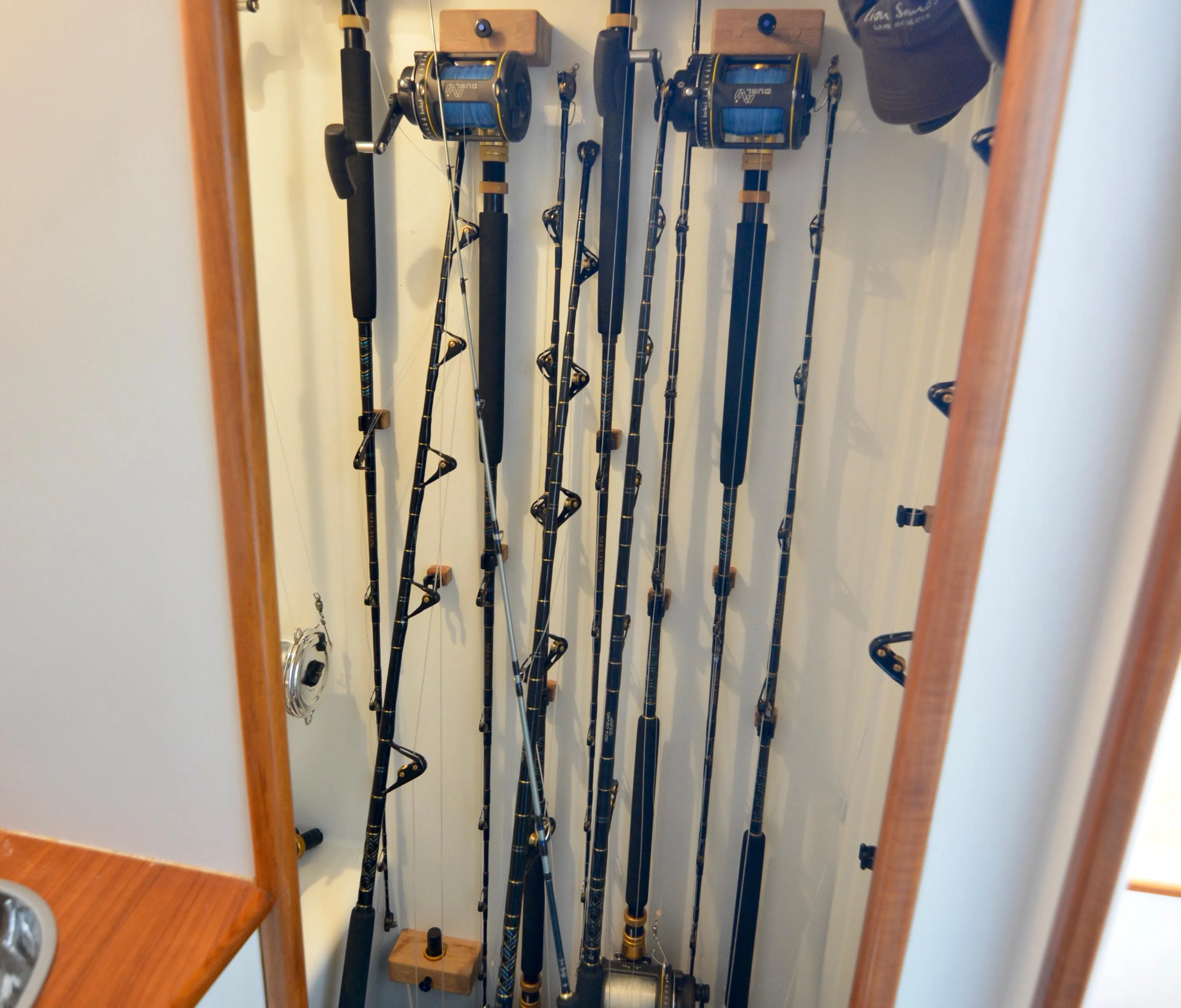 Fishing rods stored vertically in a 2007 Gamefisherman 42 Walkaround boat interior.