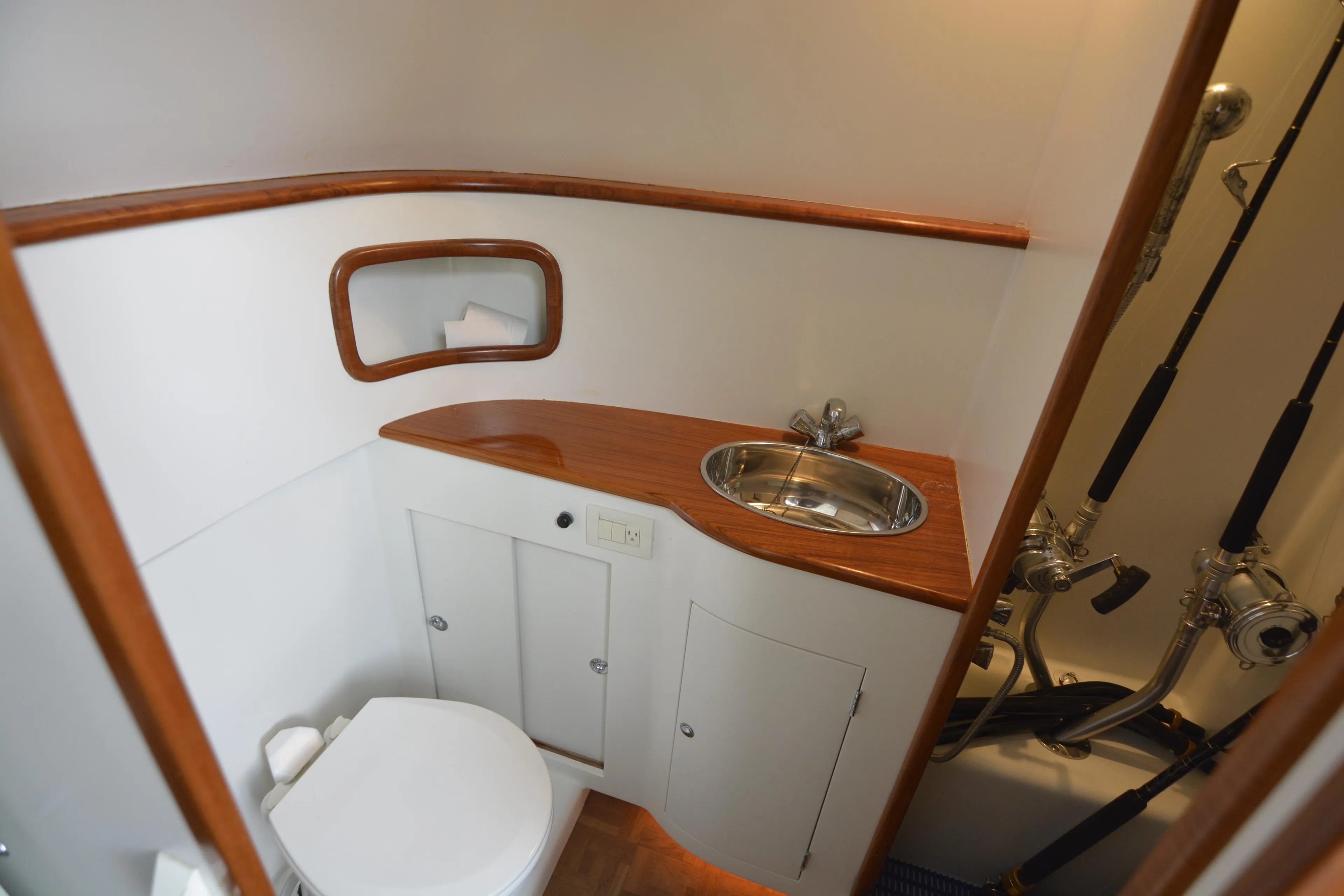 2007 Gamefisherman 42 Walkaround bathroom with wooden accents, sink, and toilet.