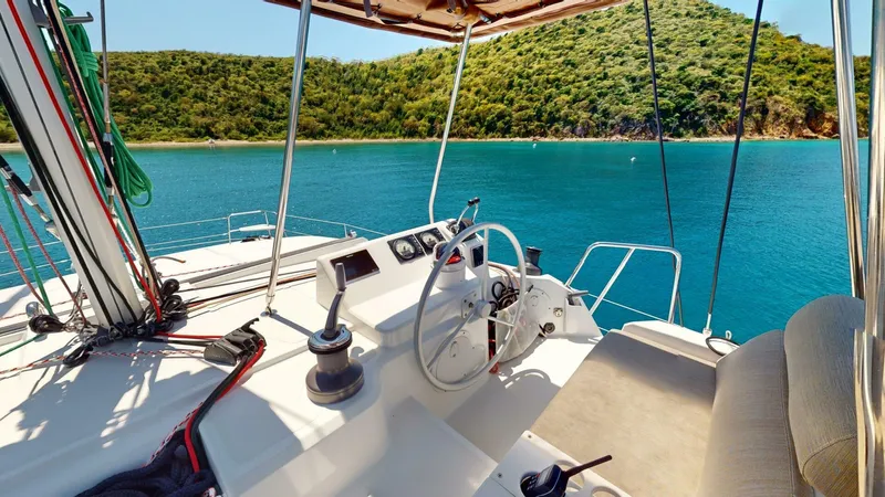 Aquatic Odyssey Yacht Photos Pics 2022 Bali CATSPACE catamaran helm with scenic ocean and lush island backdrop.