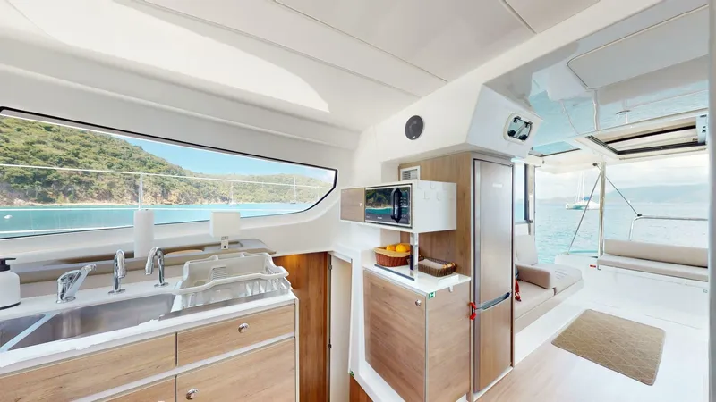 Aquatic Odyssey Yacht Photos Pics Modern kitchen interior of 2022 Bali CATSPACE catamaran with ocean view.
