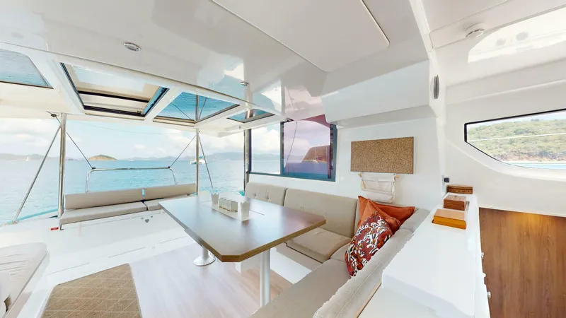 Aquatic Odyssey Yacht Photos Pics Modern interior of 2022 Bali CATSPACE catamaran with ocean view, featuring spacious seating and dining area.