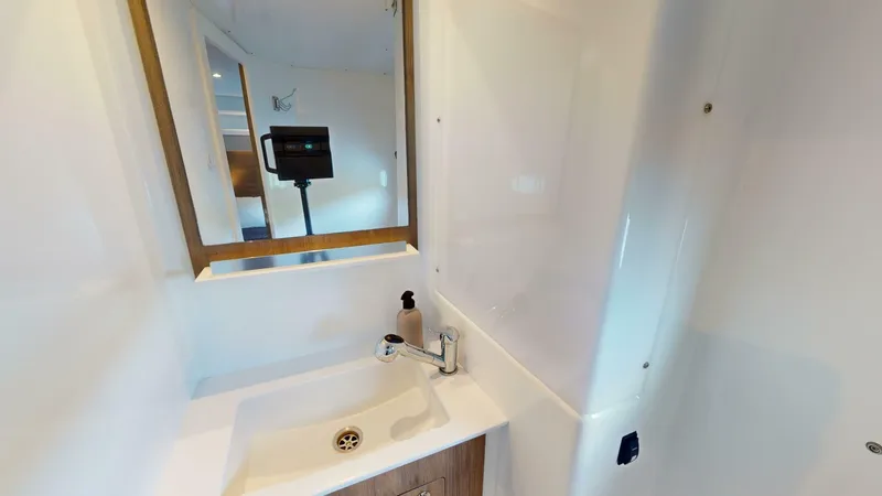 Aquatic Odyssey Yacht Photos Pics Modern bathroom interior in 2022 Bali CATSPACE yacht, featuring sink and mirror.