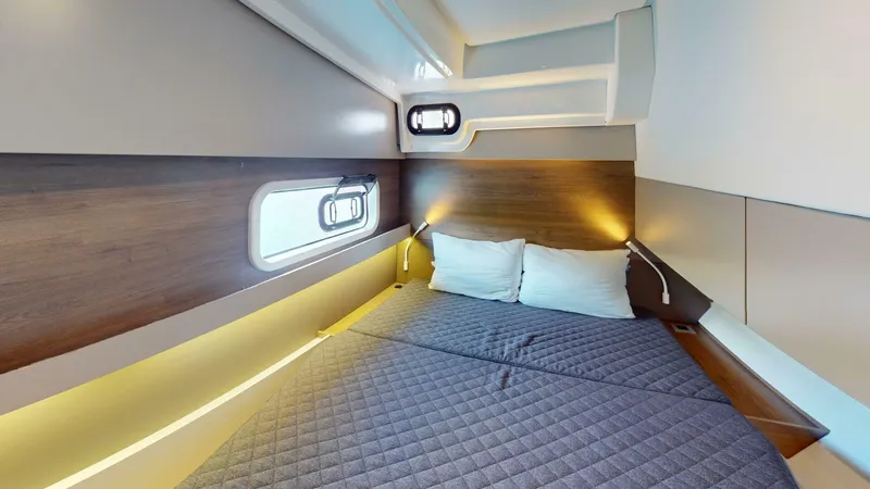 Aquatic Odyssey Yacht Photos Pics Cozy cabin interior of 2022 Bali CATSPACE yacht with modern bedding and ambient lighting.