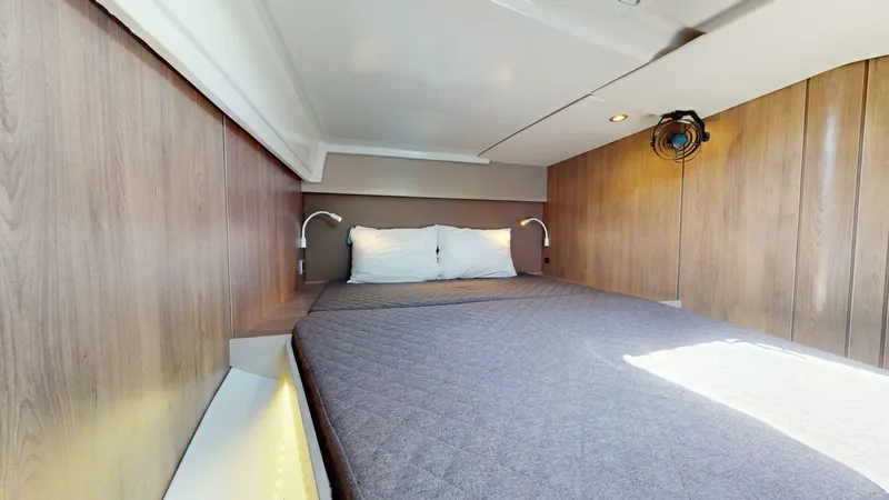 Aquatic Odyssey Yacht Photos Pics Cozy cabin interior of 2022 Bali CATSPACE with wooden walls and a comfortable bed.