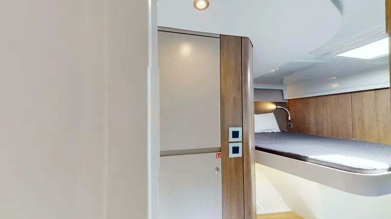 Aquatic Odyssey Yacht Photos Pics 2022 Bali CATSPACE interior with modern wood finish and cozy sleeping area.