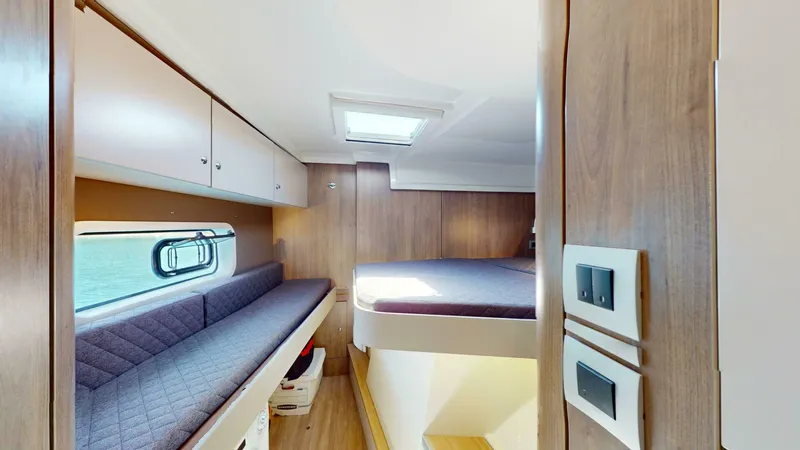 Aquatic Odyssey Yacht Photos Pics Interior of 2022 Bali CATSPACE catamaran with cozy cabin, bed, and seating area.