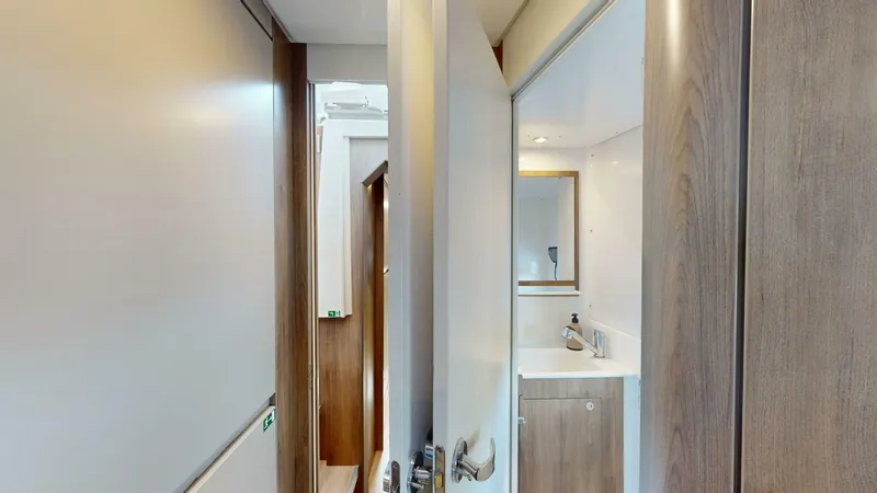 Aquatic Odyssey Yacht Photos Pics Interior view of 2022 Bali CATSPACE yacht, featuring a compact bathroom with wooden accents.