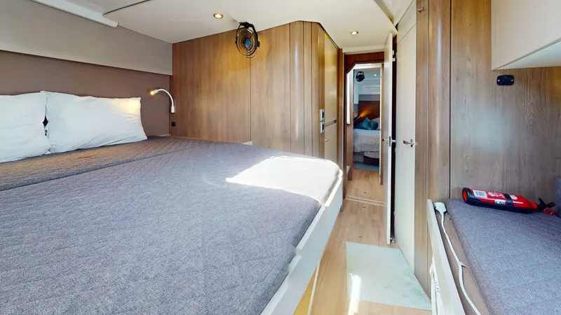 Aquatic Odyssey Yacht Photos Pics 2022 Bali CATSPACE yacht interior with cozy bedroom, wooden walls, and modern lighting.