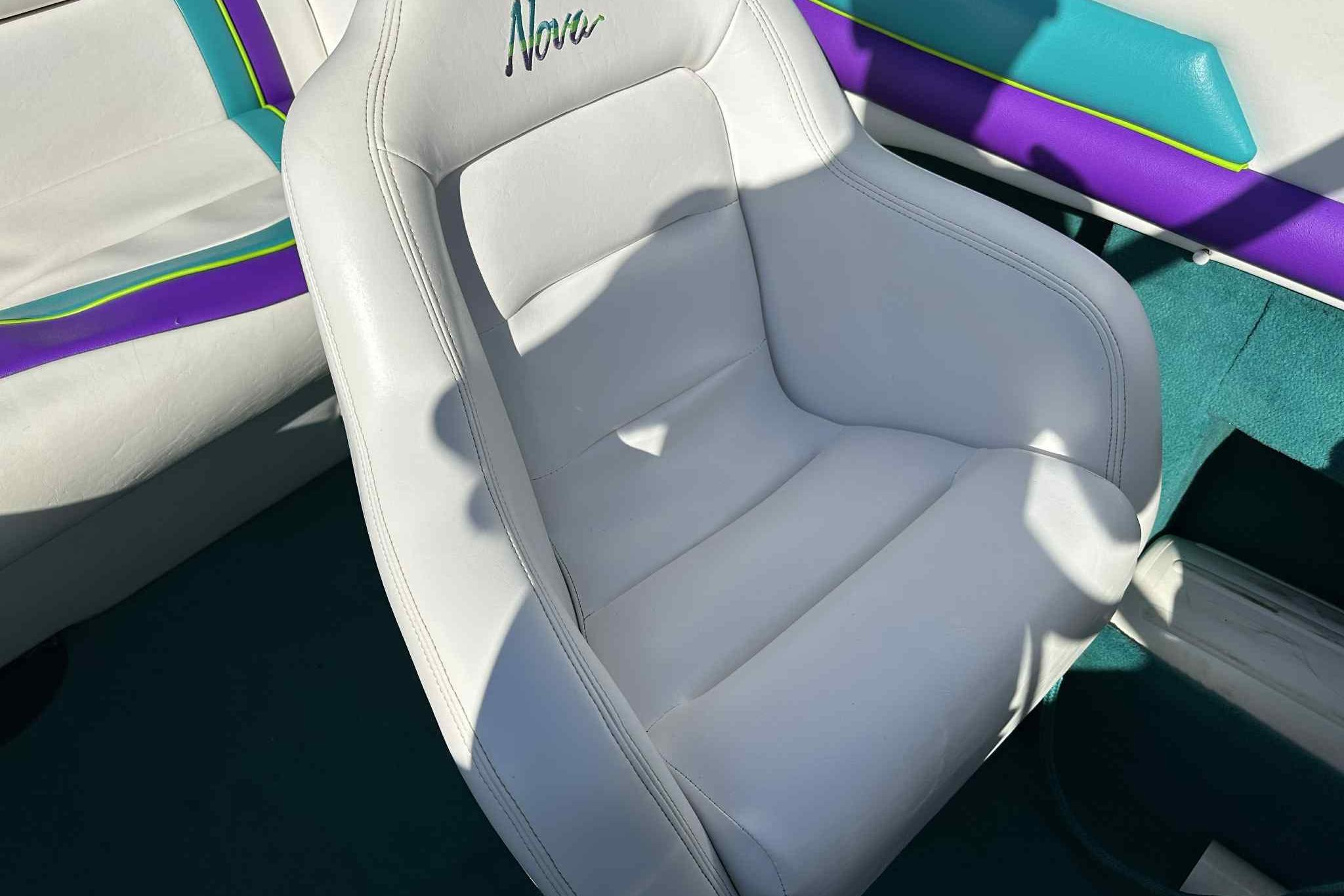 White leather seat in 1993 Nova Spyder with colorful interior accents.