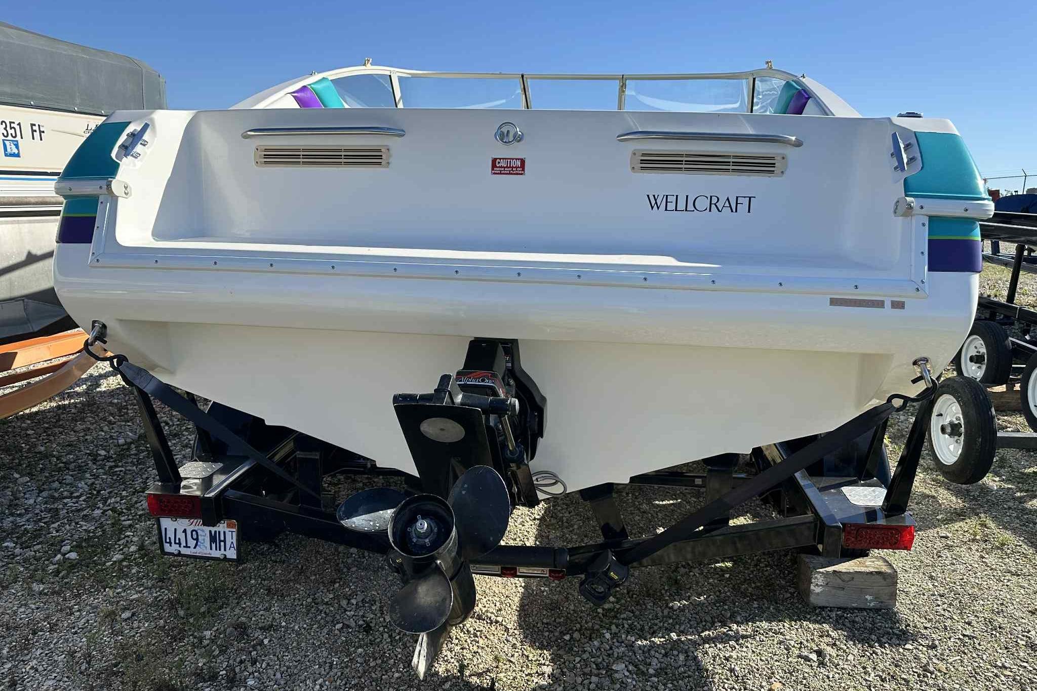 Rear view of a 1993 Nova Spyder Wellcraft boat on a trailer.