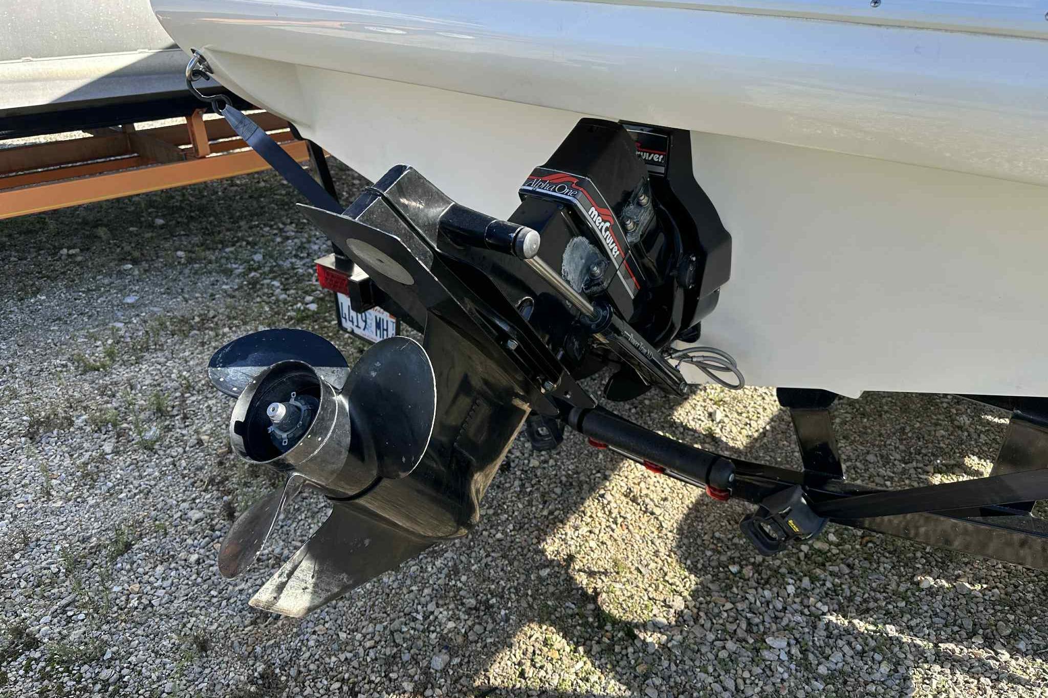 1993 Nova Spyder boat with a Mercury Alpha One outdrive on gravel surface.