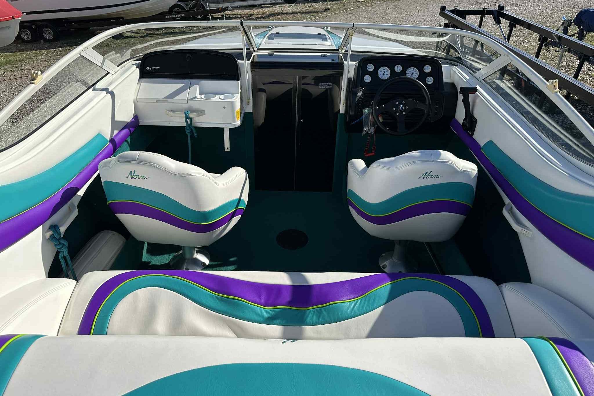 1993 Nova Spyder boat interior with vibrant teal and purple seating.