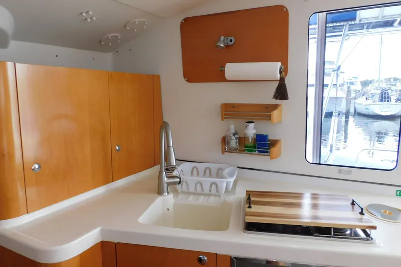 Sail La Vie Yacht Photos Pics Interior of 2007 Fountaine Pajot Mahe 36 Evolution catamaran kitchen with sink and window view.