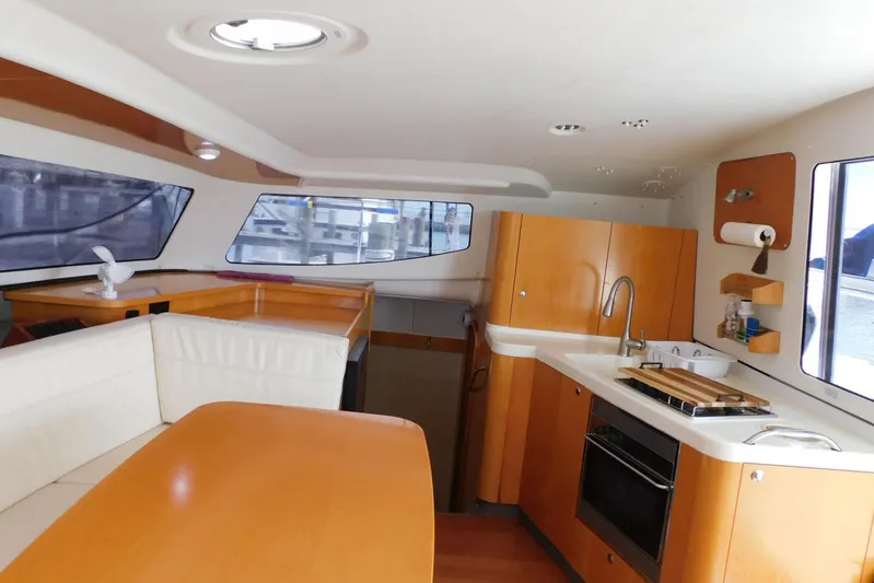 Sail La Vie Yacht Photos Pics Interior of 2007 Fountaine Pajot Mahe 36 Evolution catamaran, featuring kitchen and seating area.