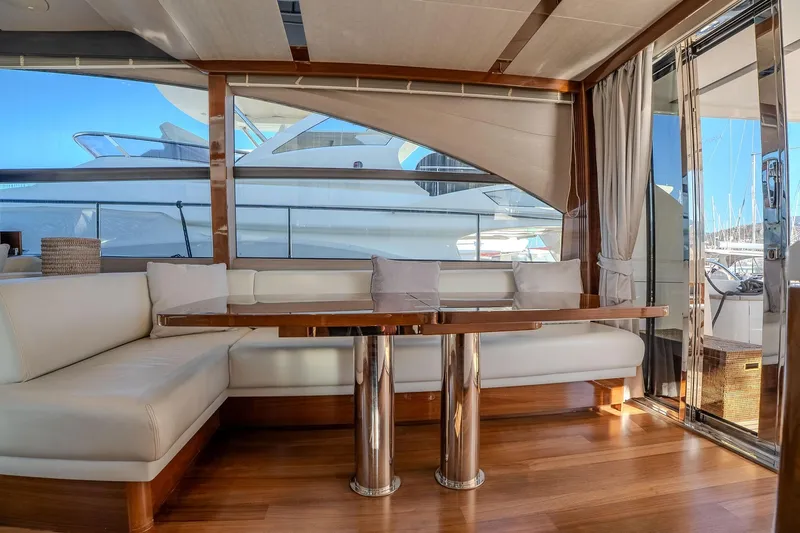 Dani Yacht Photos Pics Luxurious interior of a 2016 Princess 68 yacht with elegant seating and wooden flooring.
