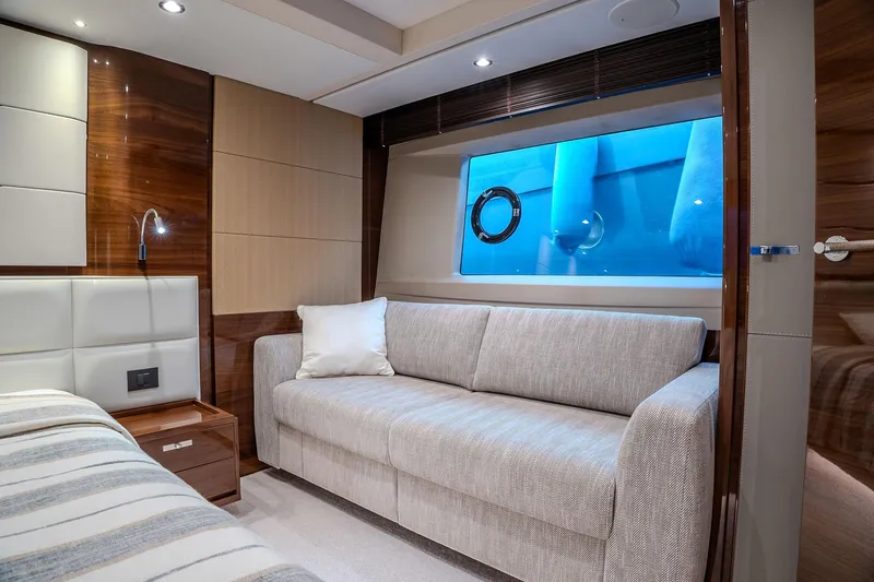 Dani Yacht Photos Pics Luxurious interior of 2016 Princess 68 yacht with sofa and ocean view window.