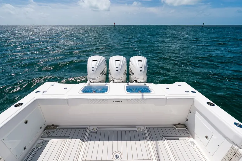 Caymas Yacht Photos Pics 2023 Caymas 401CC boat with triple engines on open ocean.