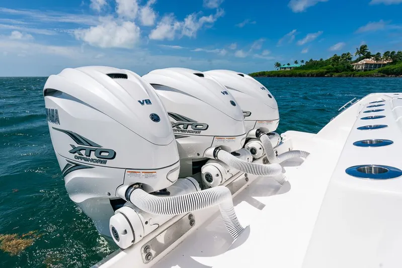Caymas Yacht Photos Pics 2023 Caymas 401CC boat with triple Yamaha XTO Offshore V8 engines on open water.