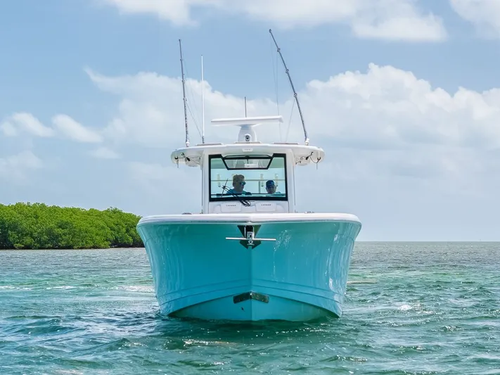 Caymas Yacht Photos Pics 2023 Caymas 401CC boat cruising on clear blue water under a sunny sky.