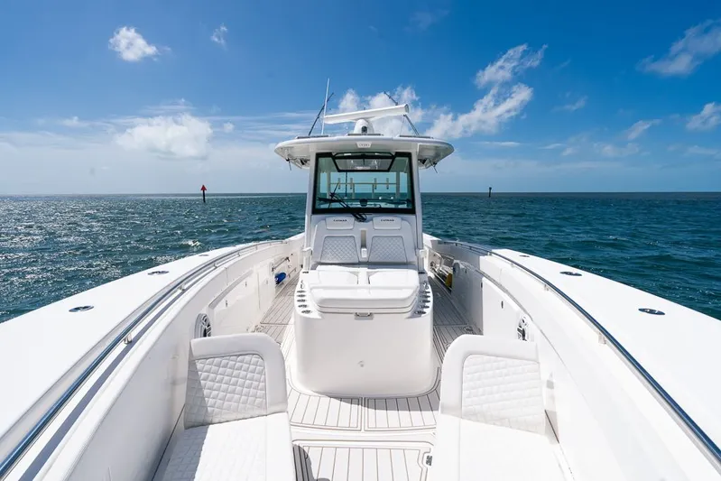 Caymas Yacht Photos Pics 2023 Caymas 401CC boat on open sea under clear blue sky.