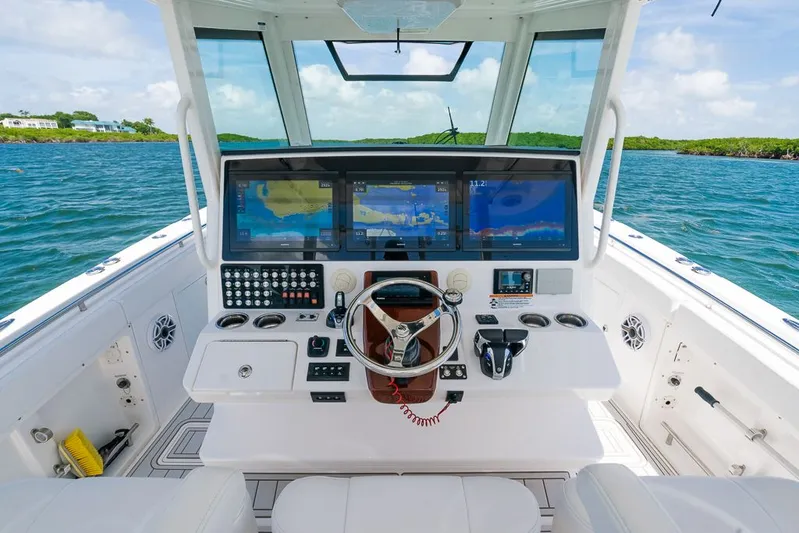 Caymas Yacht Photos Pics 2023 Caymas 401CC boat cockpit with advanced navigation screens and controls on open water.