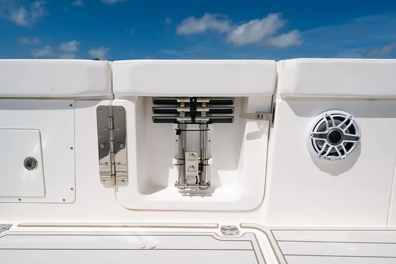 Caymas Yacht Photos Pics 2023 Caymas 401CC boat interior with speaker and storage compartment against blue sky.