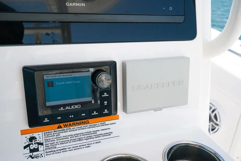 Caymas Yacht Photos Pics Control panel of 2023 Caymas 401CC featuring Garmin, JL Audio, and Seakeeper systems.