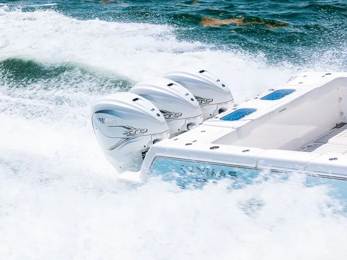 Caymas Yacht Photos Pics 2023 Caymas 401CC boat with triple Yamaha XTO engines on the ocean.