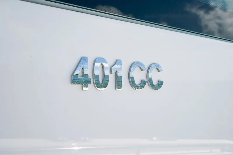 Caymas Yacht Photos Pics Close-up of 2023 Caymas 401CC model emblem on white surface.