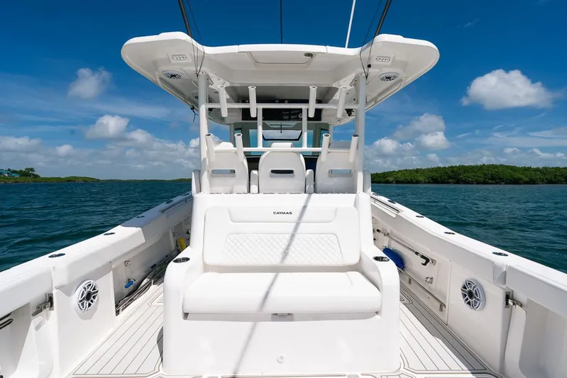 Caymas Yacht Photos Pics 2023 Caymas 401CC boat interior with white seating, on a sunny day at sea.